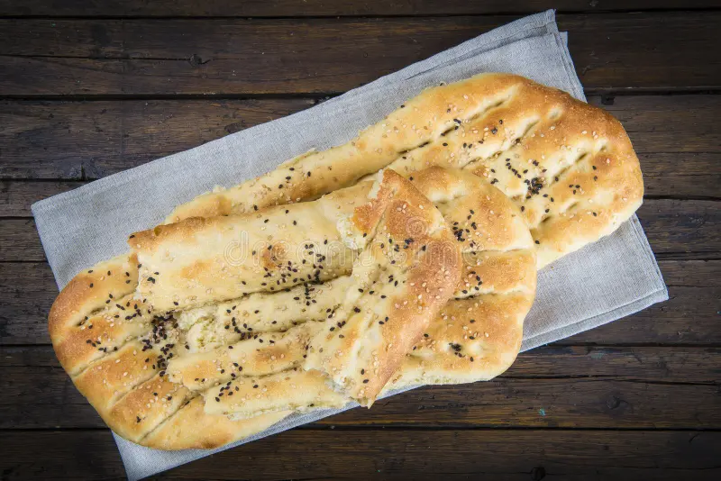 barbari-persian-bread-covered-sesame-seeds-table-68876484